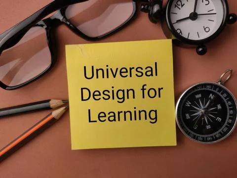 A yellow note reading Universal Design for Learning sits framed by glasses,.. Stock Photos