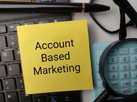 A yellow note stating Account Based Marketing lies on a laptop keyboard bes.. Stock Photos