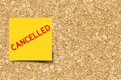 Yellow note with word cancelled on cork board background  with copy space (Ve Stock Illustration
