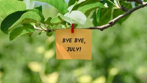 A yellow note with the words Bye Bye, July! Stock Photos