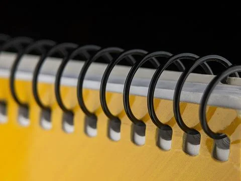 Yellow notebook on a black background. Stock Photos