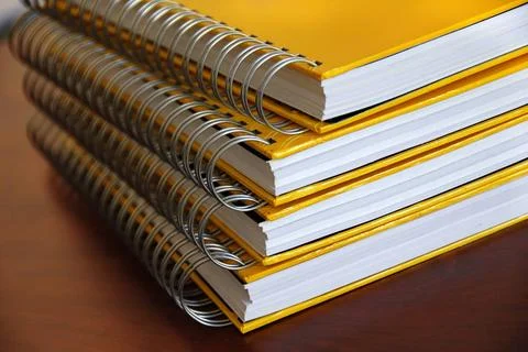 Yellow notebooks stack four yellow notebooks with ring binding stack on de... 写真素材