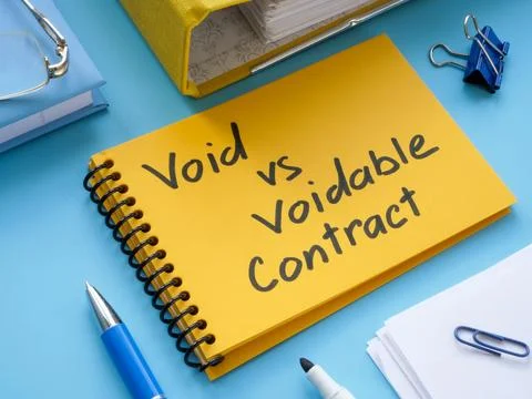 Yellow notepad with inscription void vs voidable contract. Stock Photos