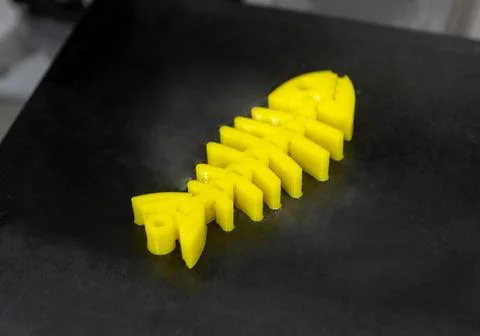 Yellow objects printed on 3D printer from plastic. New 3D printing technology. Stock Photos