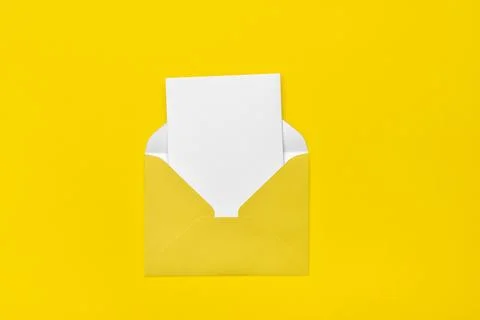 Yellow open envelope on a yellow background with a note inside. Place for y.. Stock Photos