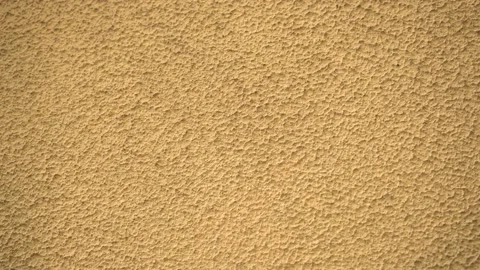 Yellow or orange background decorative plaster or putty facade of the building. Stock Footage 98170621
