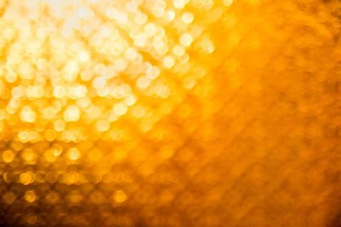 Yellow orange defocused background. Abstract texture for holidays and christmas. Stock Photos