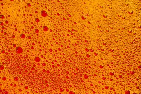 Yellow-orange liquid soap bubbles as a background or graphic resource. Stock Photos