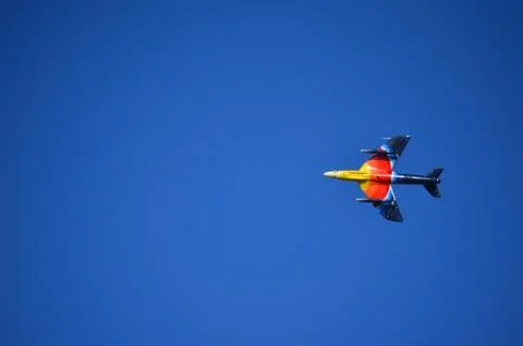 Yellow, Orange, Red and Blue Fighter Aircraft flying Left Stock Photos