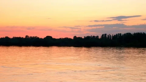 Yellow-orange sunset over river island Stock Footage 75660367