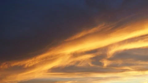 Yellow orange sunset sky clouds. The soft, warm hue of yellow casts a serene and Stock Footage 254695454