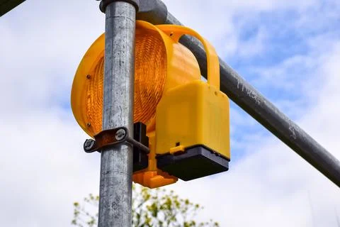 Yellow Orange Warning Flashing Light on Metal Pole Road 스톡 사진
