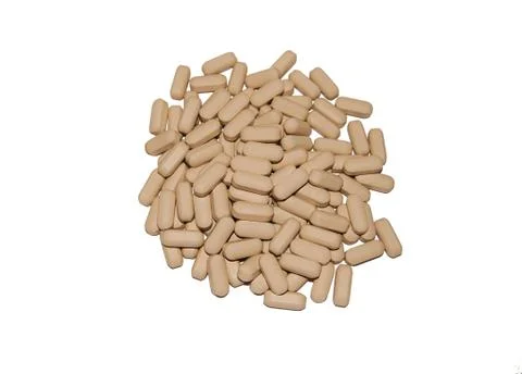Yellow oval tablets isolate on white background Foto stock