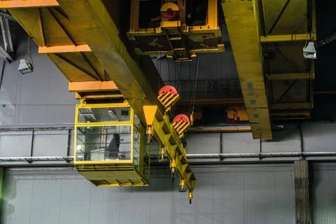 Yellow overhead crane with linear traverse and hooks Stock Photos