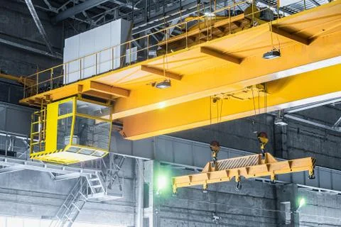 Yellow overhead crane with linear traverse and hooks Stock Photos