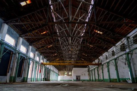 Yellow overhead crane spanning the sky over the old workshop Stock Photos