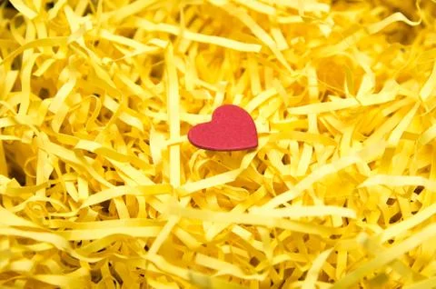 Yellow packaging material and red heart model Stock Photos