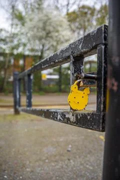 Yellow Padlock on the barrier post in a restricted area in London. Stock Photos