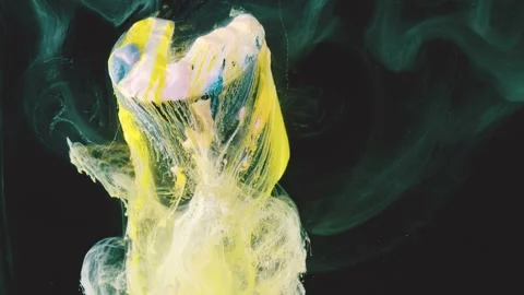 Yellow paint cloud transforming into delicate filaments against dark background  Stock Footage 341464511