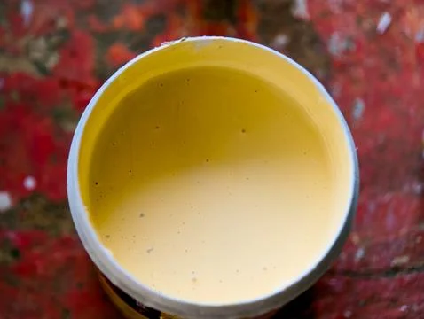 Yellow paint in a container ready for artistic use Stock Photos