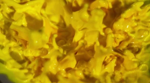 Yellow paint dancing up and down on top of a speaker - overhead shot Stock Footage 63978344