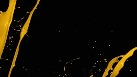 Yellow paint splash thrown in slow motion, liquid isolated on black (4K) Stock Footage 137112703