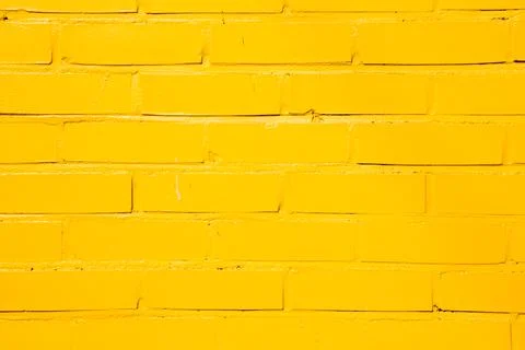 Yellow painted brick wall background Fotos Stock