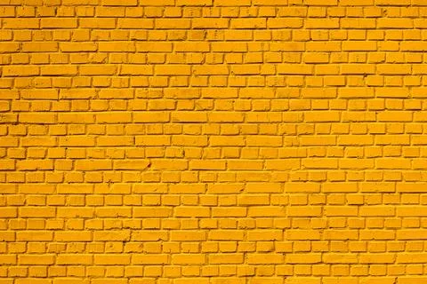 Yellow painted brick wall pattern for background Stock Photos
