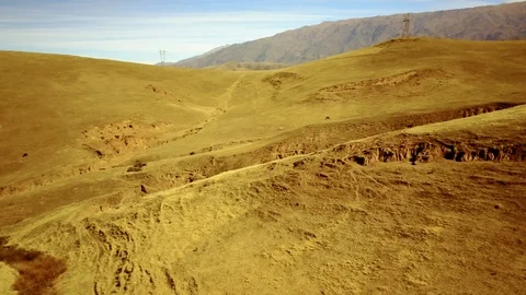 Yellow panoramic view of valley with mountain background, cloudy day aerial shot Stock Footage 89819655