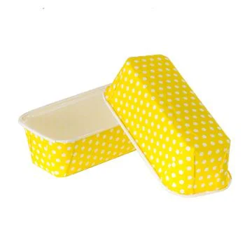 Yellow paper baking forms for cakes with dotted pattern Stock Photos