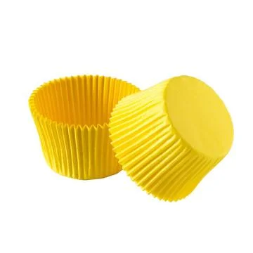 Yellow paper baking forms for muffins and cupcakes Stock Photos