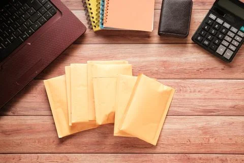 Yellow paper bubble envelope on table Stock Photos