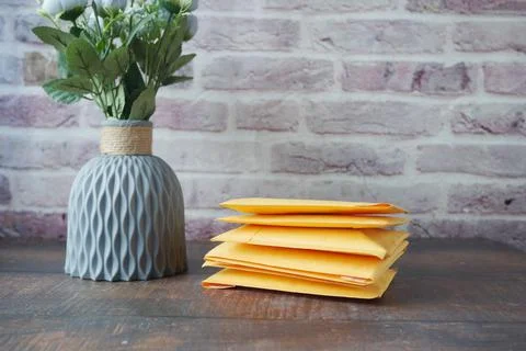 Yellow paper bubble envelope on table Stock Photos