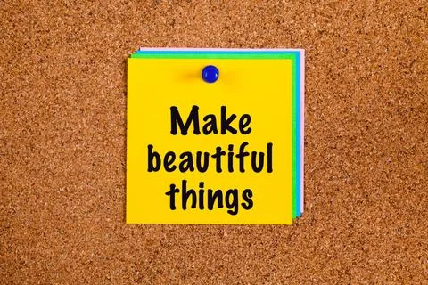 Yellow paper notes with words Make Beautiful Things on a corkboard Stock Photos