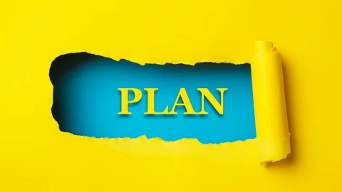 Yellow paper is torn over blue background with word "plan", stop motion. Stock Footage 121358844