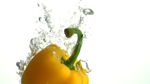A yellow paprika falling down under the water Stock Footage 101611882