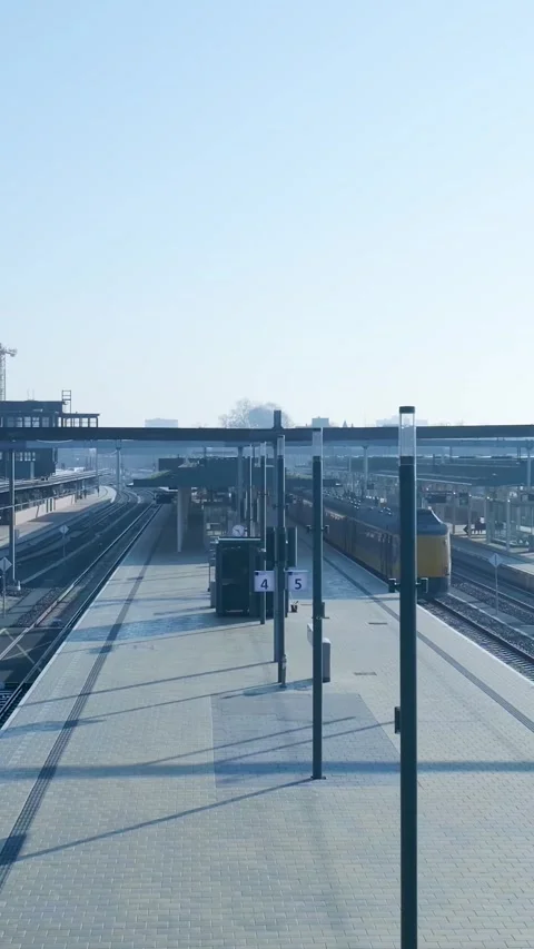 Yellow passenger train arriving at an empty modern railway station Video stock 334420075