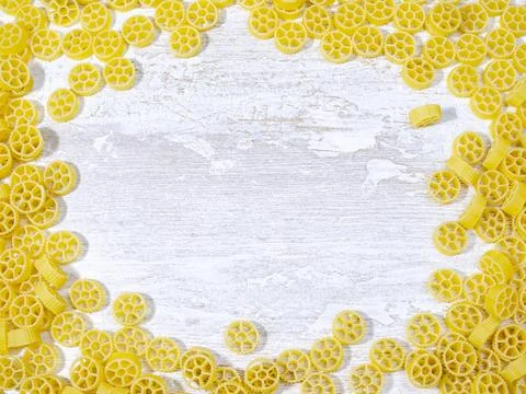Yellow pasta on a white kitchen table Stock Photos