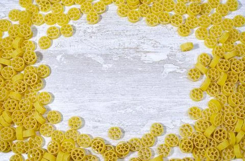 Yellow pasta on a white kitchen table Stock Photos