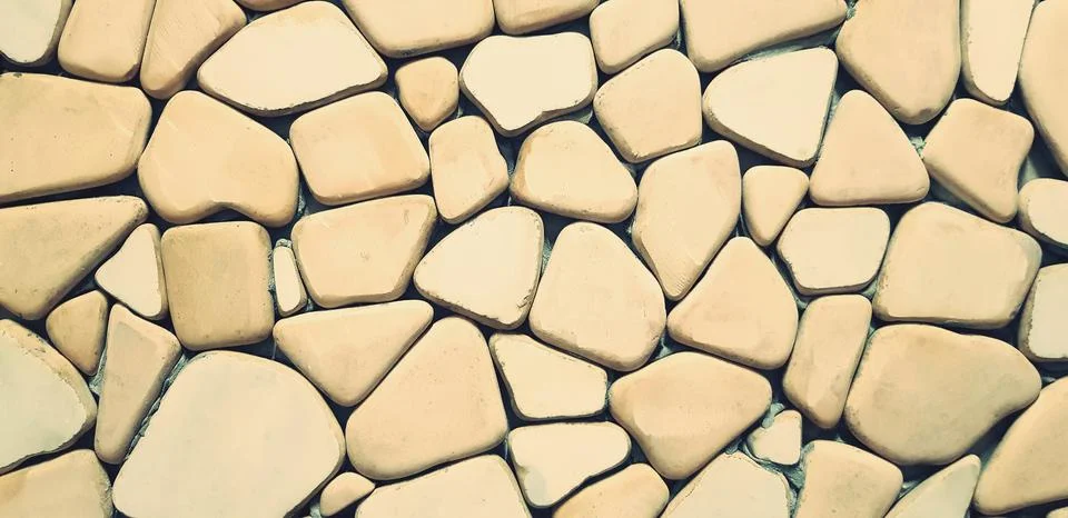 Yellow pattern of stone wall for background. Art and Textured wallpaper conce Stock Photos