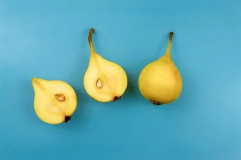 Yellow pears on blue background Stock Photos