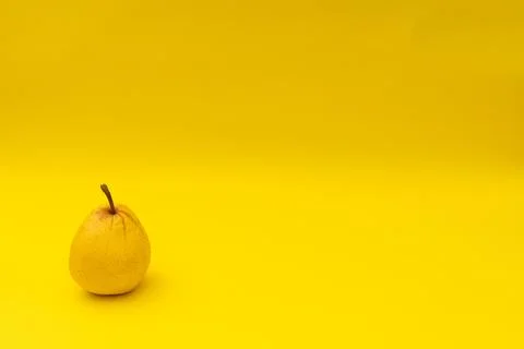Yellow pears on a yellow background Stock Photos