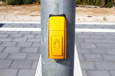Yellow Pedestrian Push Button Box with Hand Symbol on Metal Pole Stock Photos