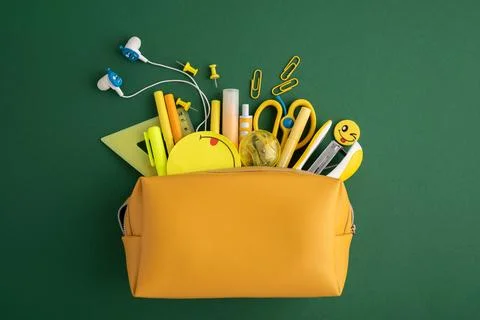 Yellow pencil case opening with school supplies Stock Photos
