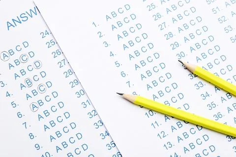 Yellow pencils on answer sheets, top view Stock Photos
