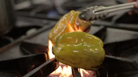Yellow pepper being cooked fire stove metal industrial restaurant roasted pepper 스톡 동영상 160018036