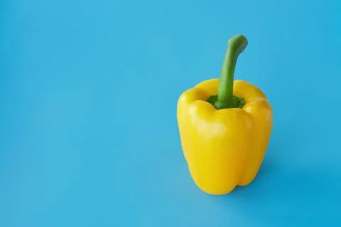 Yellow pepper on blue background Stock Photos