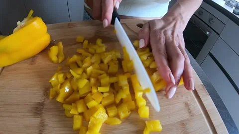 Yellow pepper cut into cubes in the cutting board Stock Footage 145891332