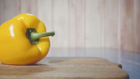 Yellow pepper on cutting board Stock Footage 73816244