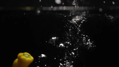 Yellow Pepper Falling Into Water Stock Footage 254598558